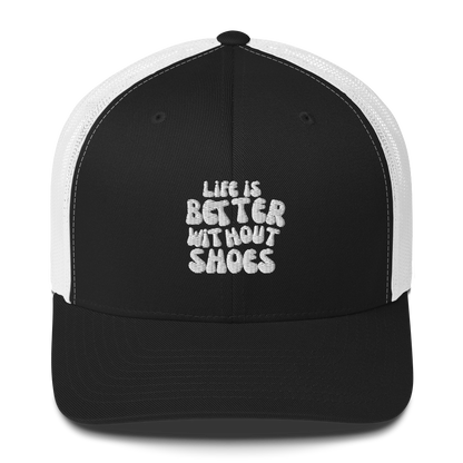 Black and white cap with 'Life is Better Without Shoes' text on a white background