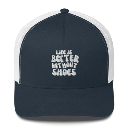 Navy blue and white cap with 'Life is Better Without Shoes' text on a white background